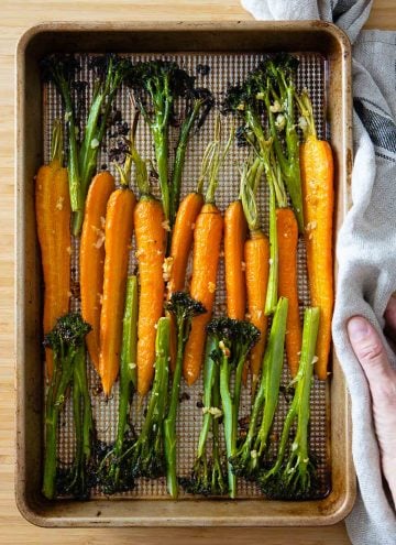 Roasted carrots and broccolini on a baking sheet.