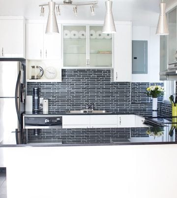 The New Kitchen of Green Healthy Cooking. White cabinets, black backsplash and countertops.
