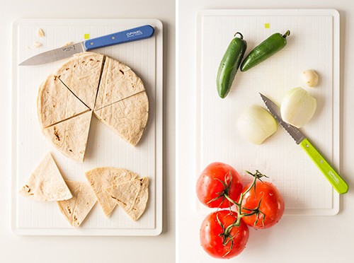 Left: tortillas cut into triangles with a knife on a cutting board. Right: serrano chiles, onion cut in half, and tomatoes on a cutting board.