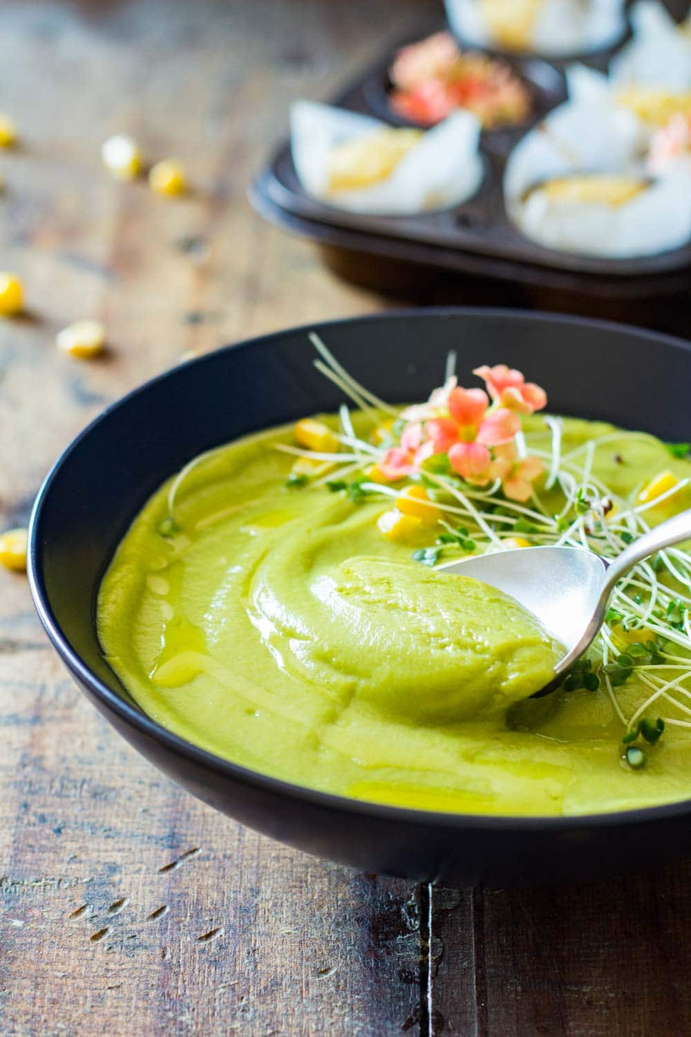 Close up of a spoon grabbing some Vegan Cream Broccoli Soup from the bowl.