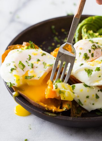 Close up of a fork grabbing a piece of Instant Pot Sweet Potatoes from a plate.