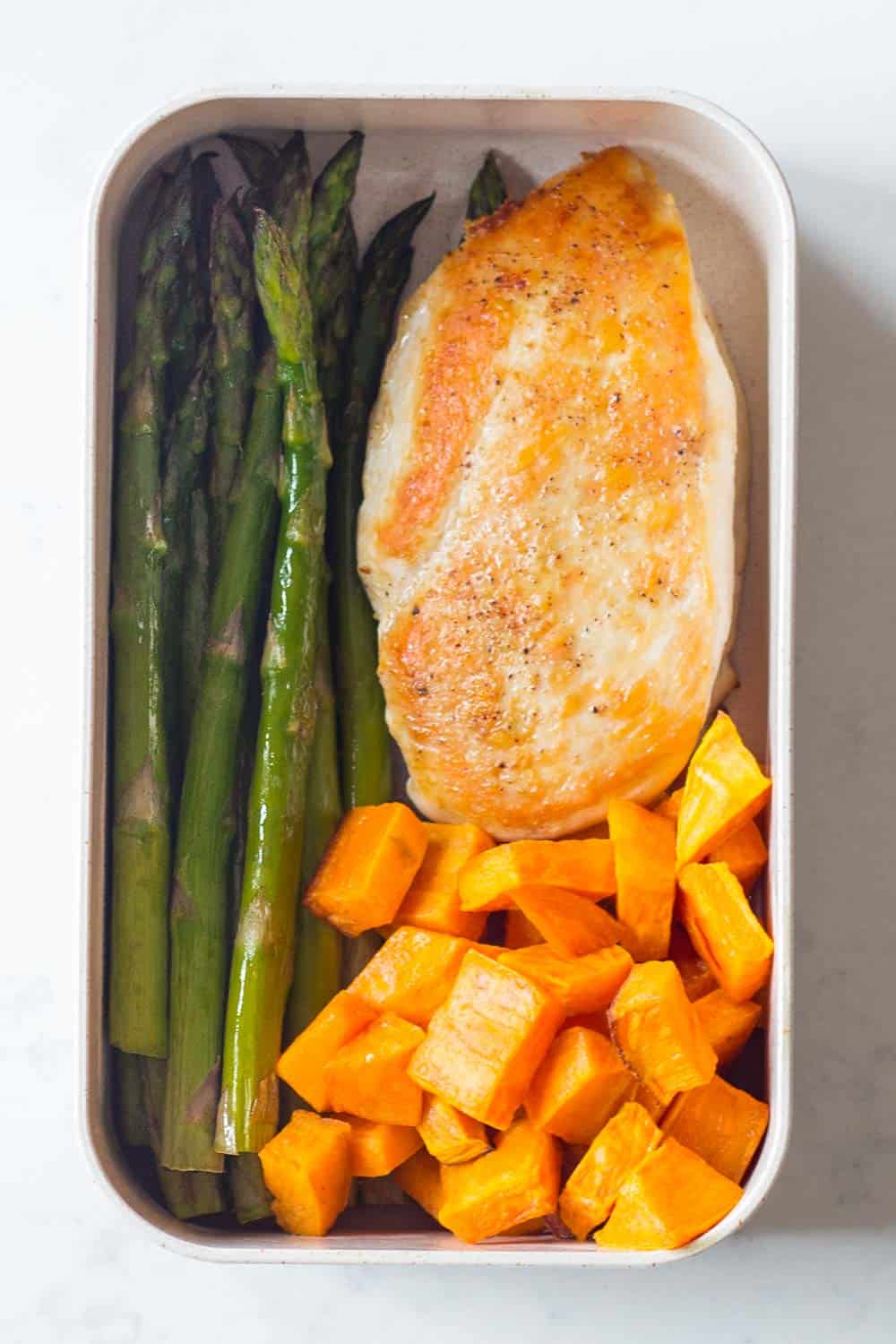 A healthy Paleo Lunch for your Paleo Meal Plan - pan fried chicken breast with roasted sweet potato and asparagus.