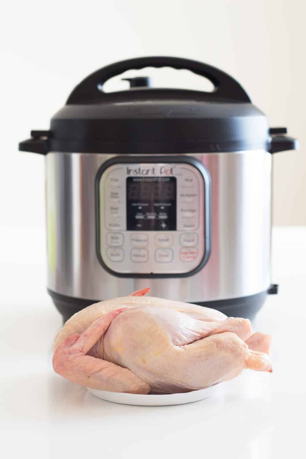 The longest experiment of all times: Instant Pot Chicken. How long to pressure cook a whole chicken, chicken legs, chicken thighs, chicken drumsticks, chicken wings AND chicken breasts. I've got chicken coming out of my ears now! A whole chicken on a plate in front of an Instant Pot
