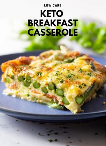 Piece of low carb breakfast casserole with asparagus and melted cheese on a blue plate
