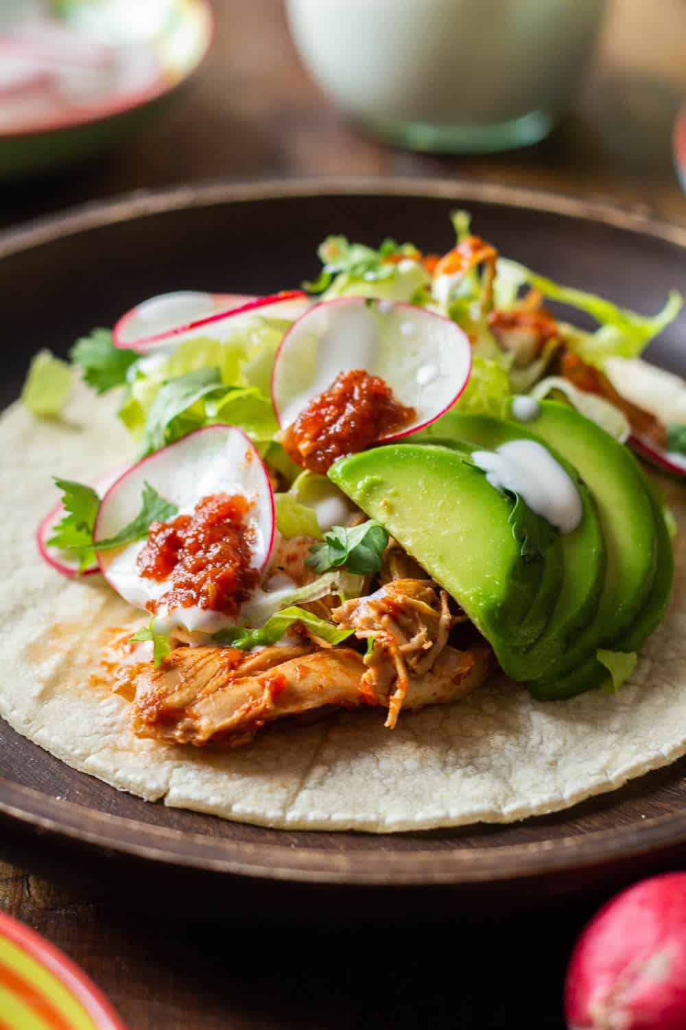 Corn Tortilla with Crockpot Chicken Tinga, lettuce, radish, avocado and sour cream