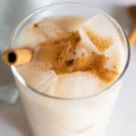 Agua de Horchata in a glass sprinkled with cinnamon. Closeup photo to show texture.