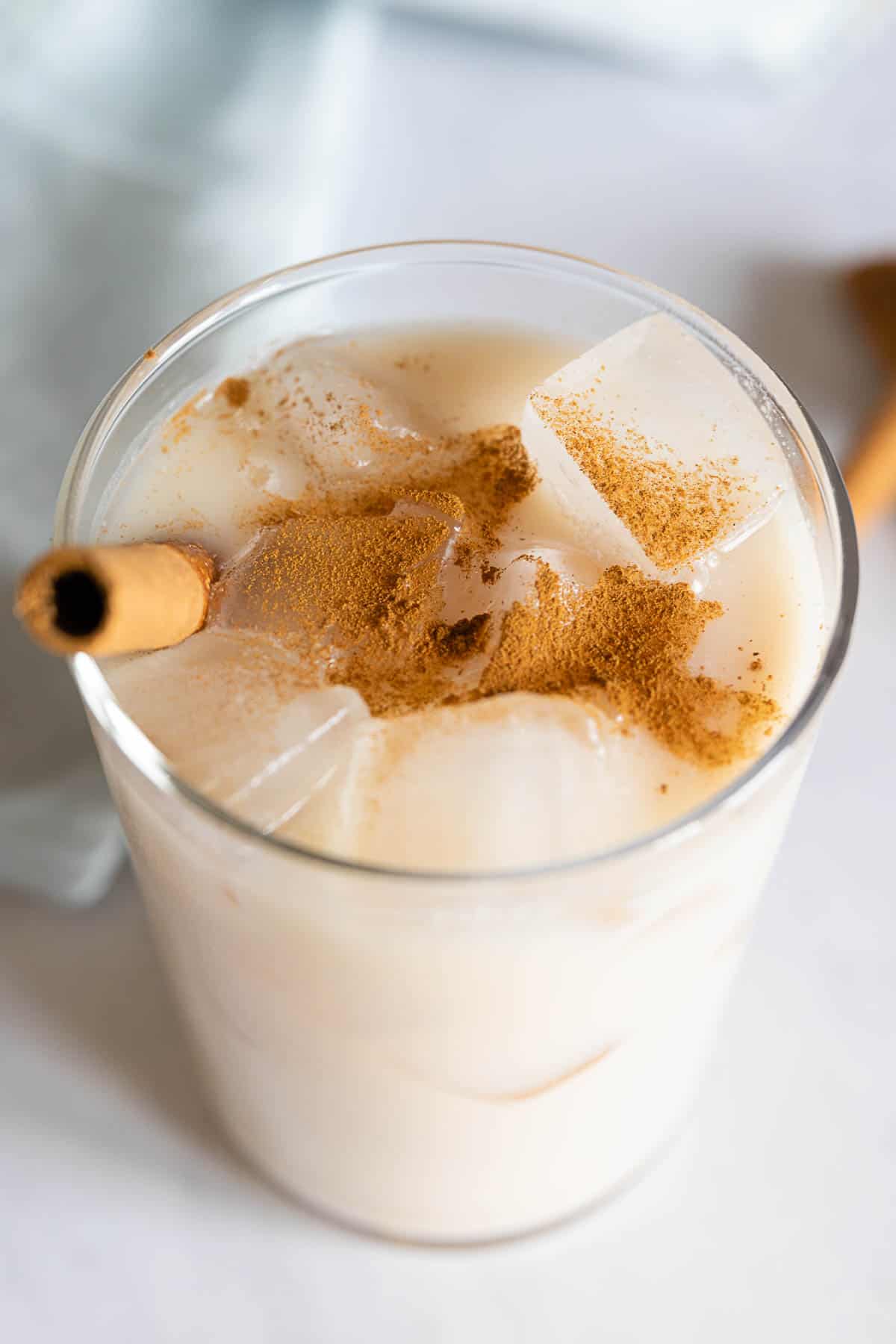 Agua de Horchata in a glass sprinkled with cinnamon. Closeup photo to show texture.
