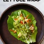 Chicken Lettuce Wrap on a wooden plate and text overlay for pinterest