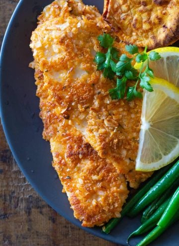 Breaded sole fish fillet on a plate.