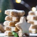 Zimtsterne, cinnamon stars, stacked one on top of the other and one leaning agains the stack.