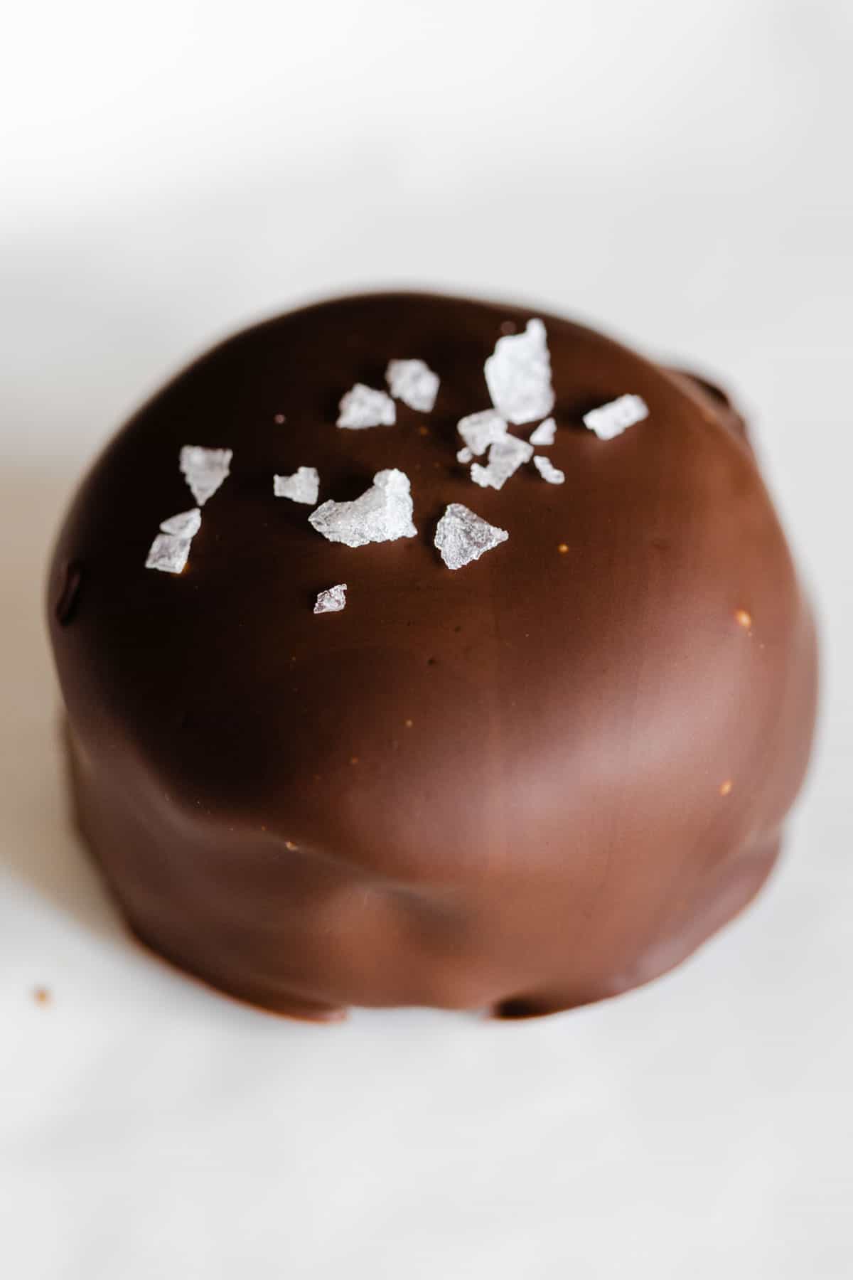 One unbitten chocolate covered banana bite with sea salt on top.