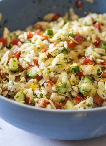 Mixed Lemon Orzo Salad in a blue salad bowl.