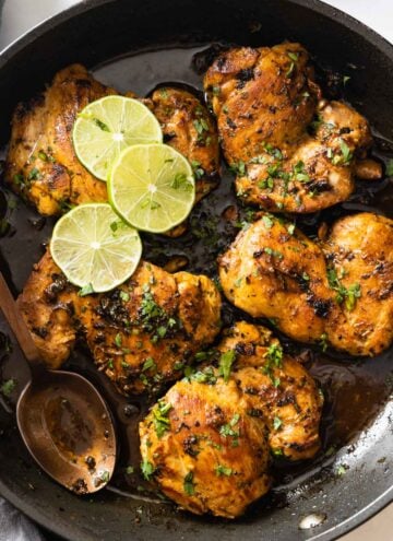 Closeup shot of texture of cooked cilantro lime chicken thighs in a pan.