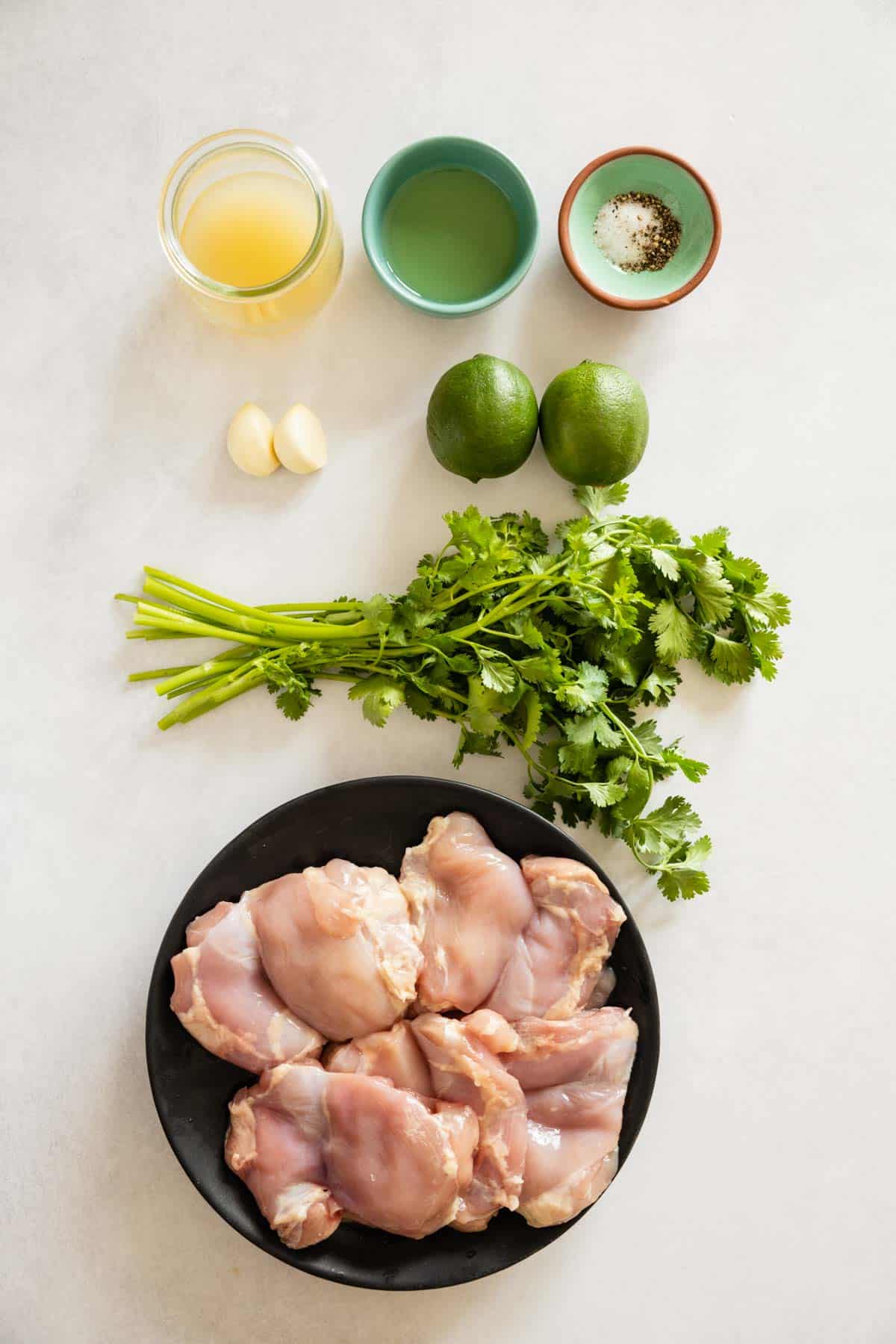 Ingredients for cilantro lime chicken thighs laid out on a kitchen counter.