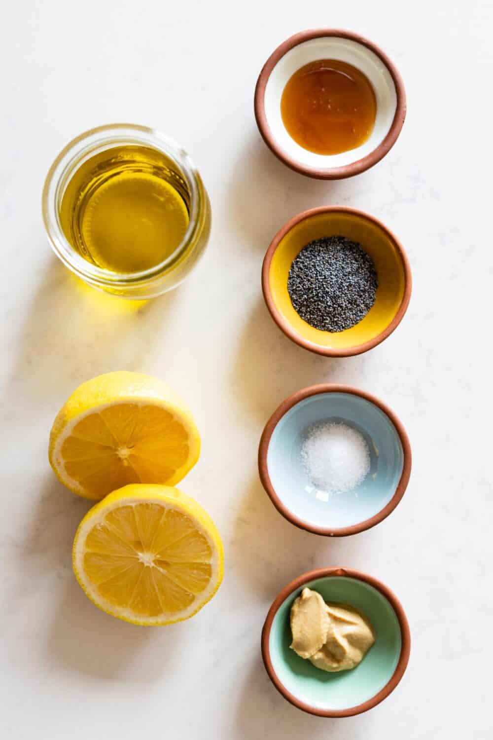 Ingredients for Lemon Poppy Seed Dressing laid out on a kitchen counter.