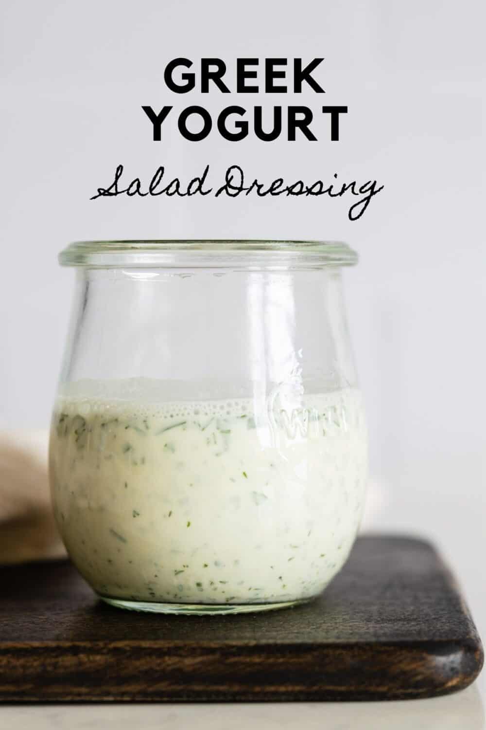 Glass jar with white salad dressing with title reading: Greek Yogurt Salad Dressing.