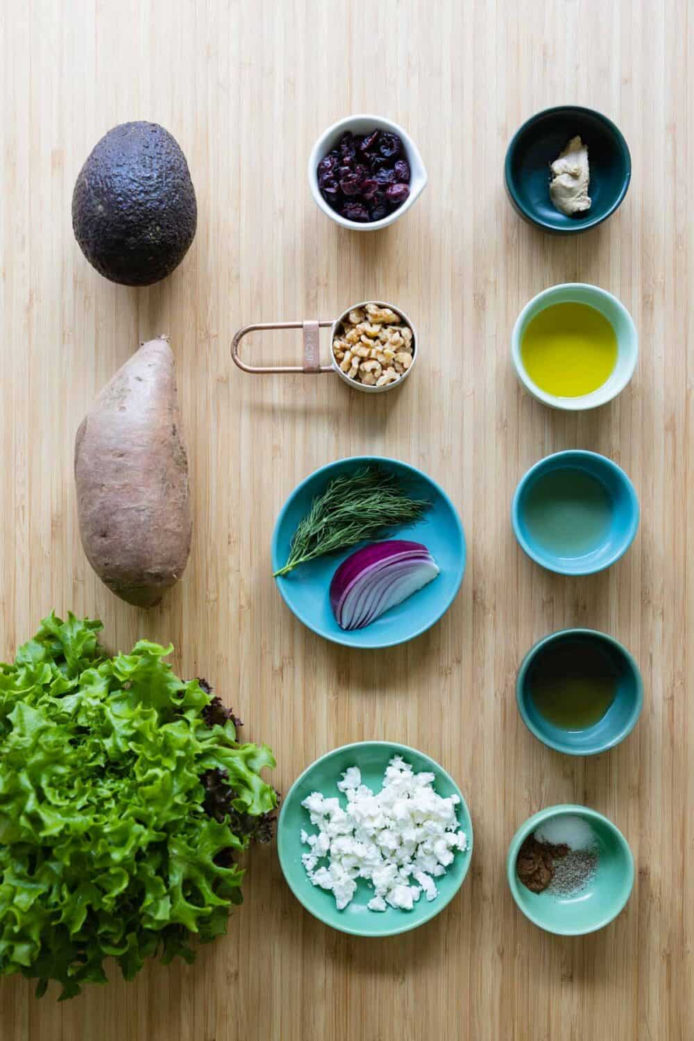 Ingredients for roasted sweet potato salad laid out on a kitchen counter.
