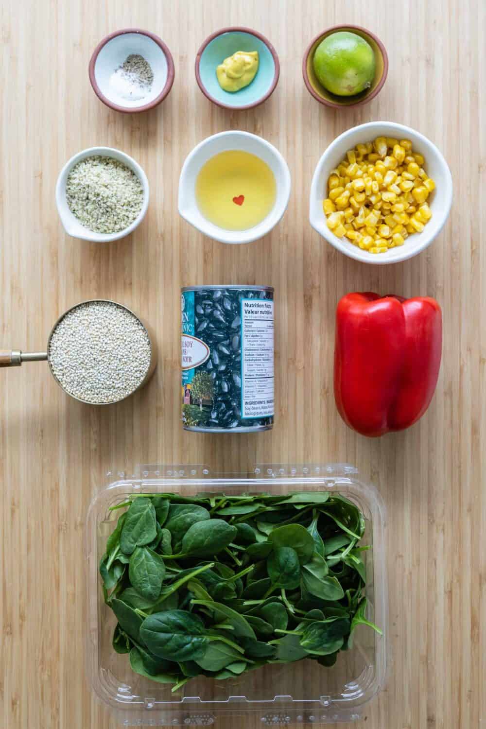 Ingredients for black bean quinoa meal prep bowls laid out on a kitchen counter.