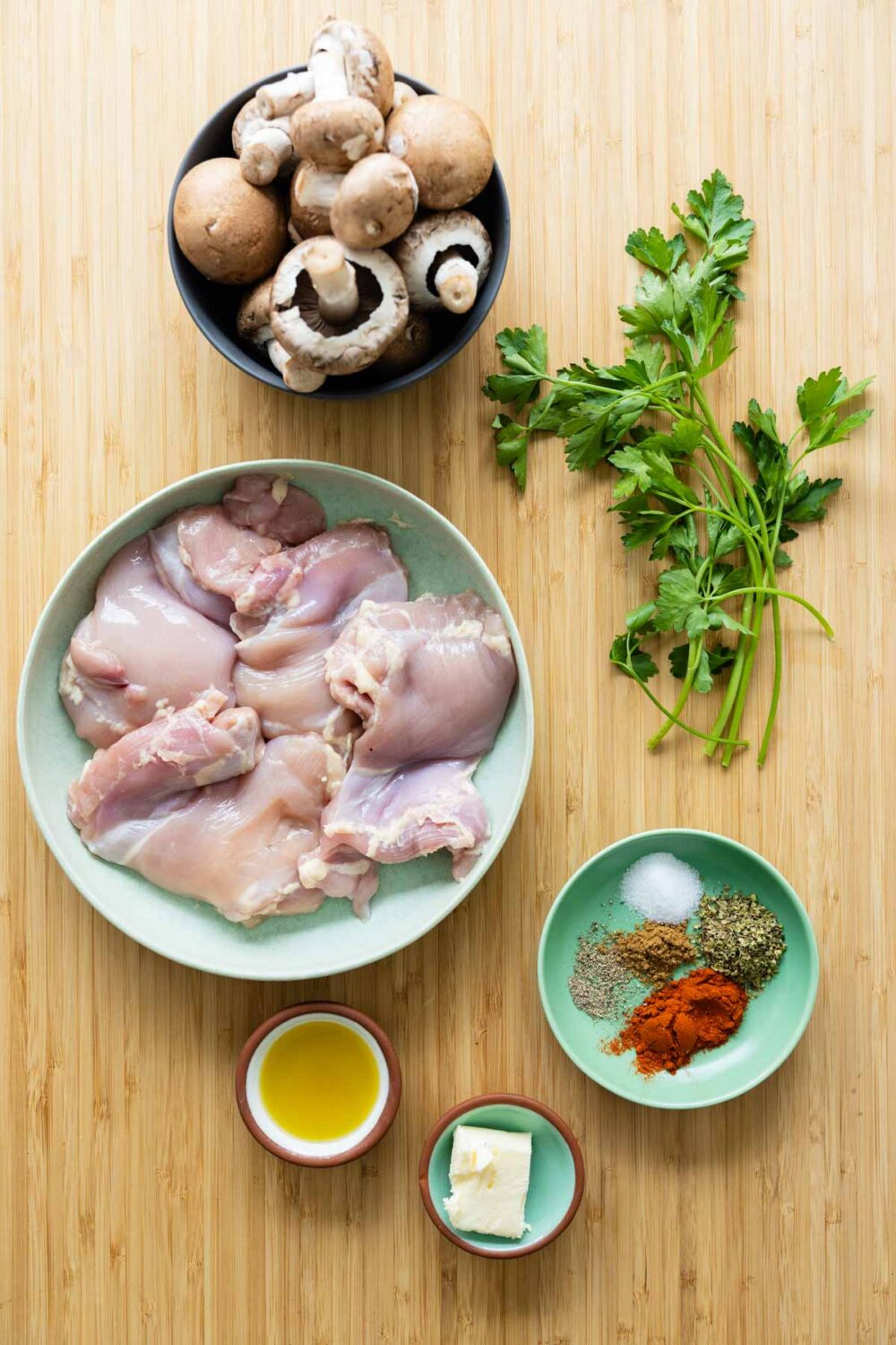 Ingredients for mushroom chicken recipe laid out on a kitchen counter.