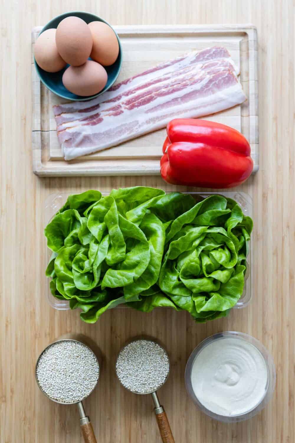 Ingrediens for Egg Quinoa meal prep bowls laid out on a kitchen counter.