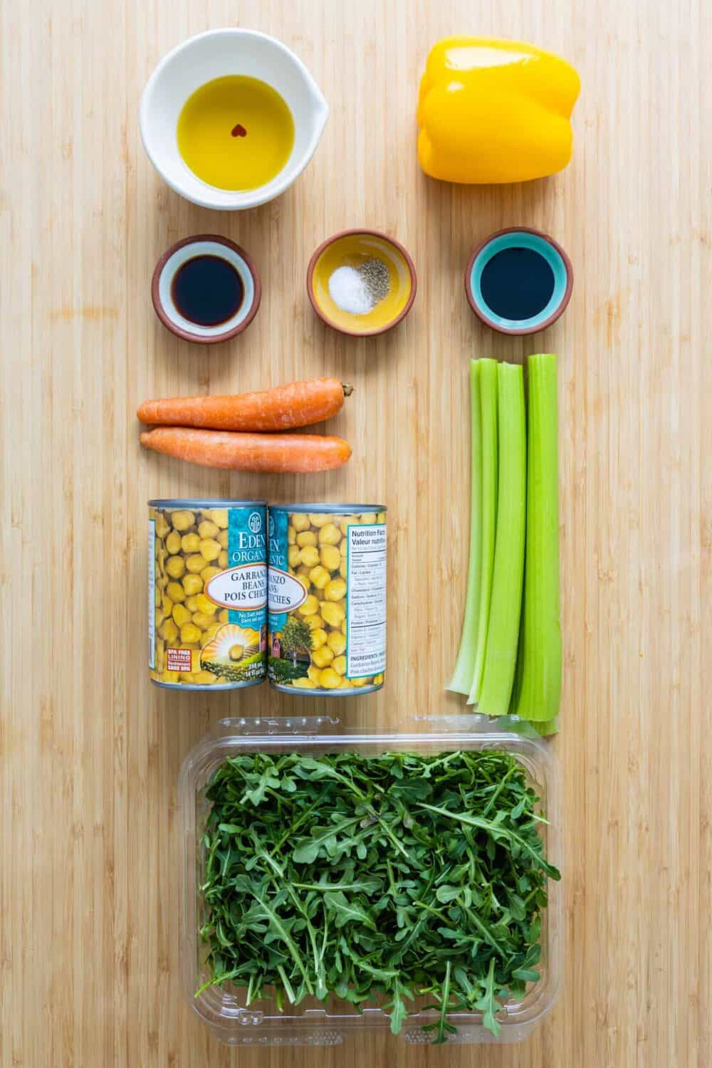 ingredients for chickpea salad laid out on a kitchen table.
