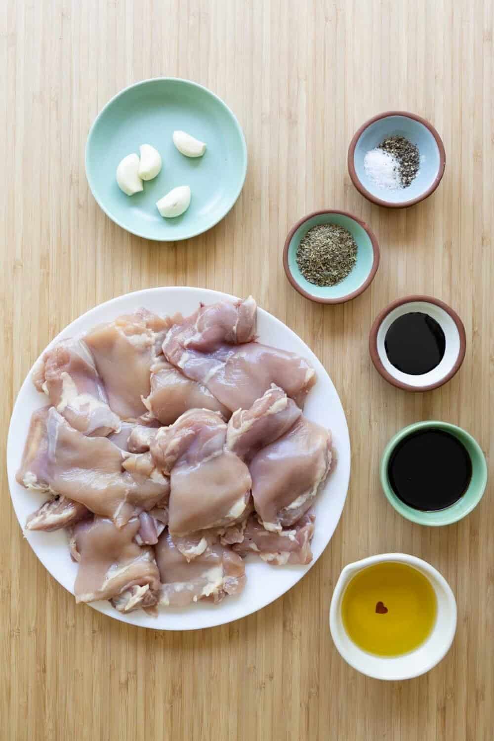 Ingredients for Balsamic Grilled Chicken laid out on a kitchen counter.