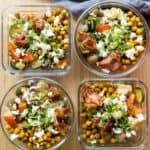Four meal prep containers filled with chickpeas and vegetables.