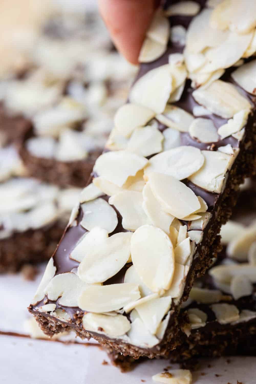 Close-up shot of one granola bar with sliced almonds on top.