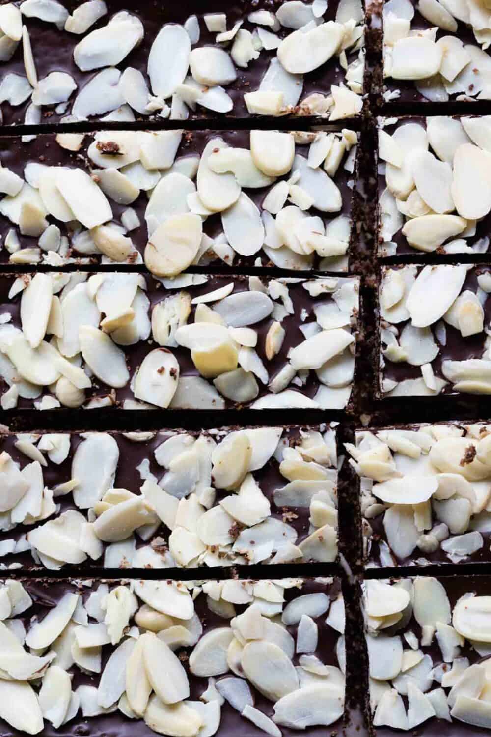 Top-down shot of freshly cut granola bars with sliced almonds on top.