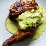 Pollo a a la brasa with ají verde sauce on top.