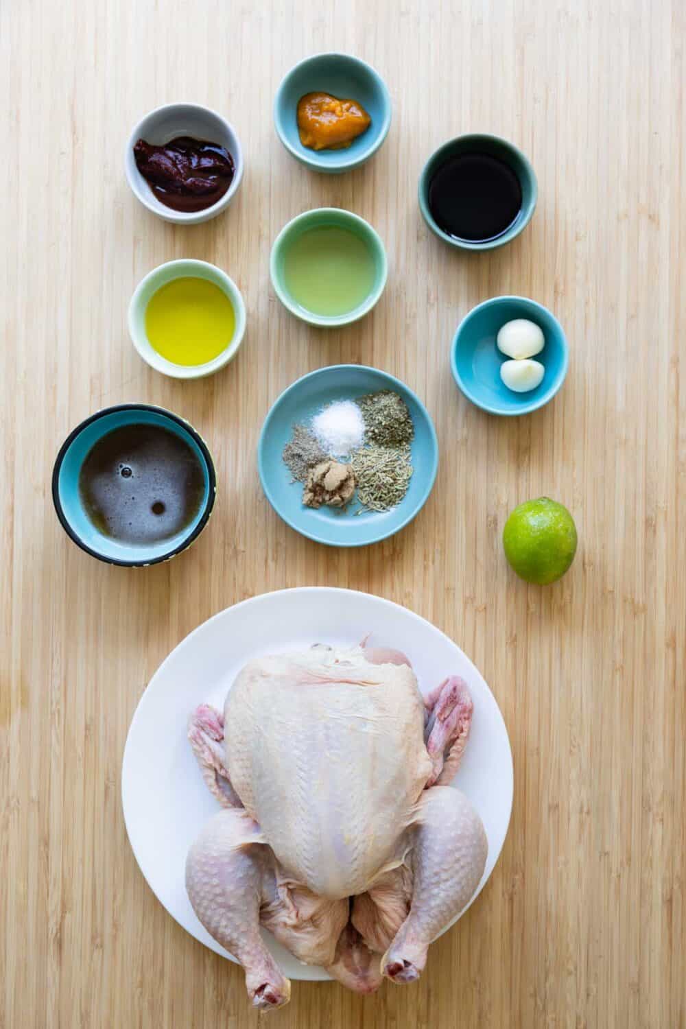 Ingredients to make pollo a la brasa laid out on a kitchen counter.