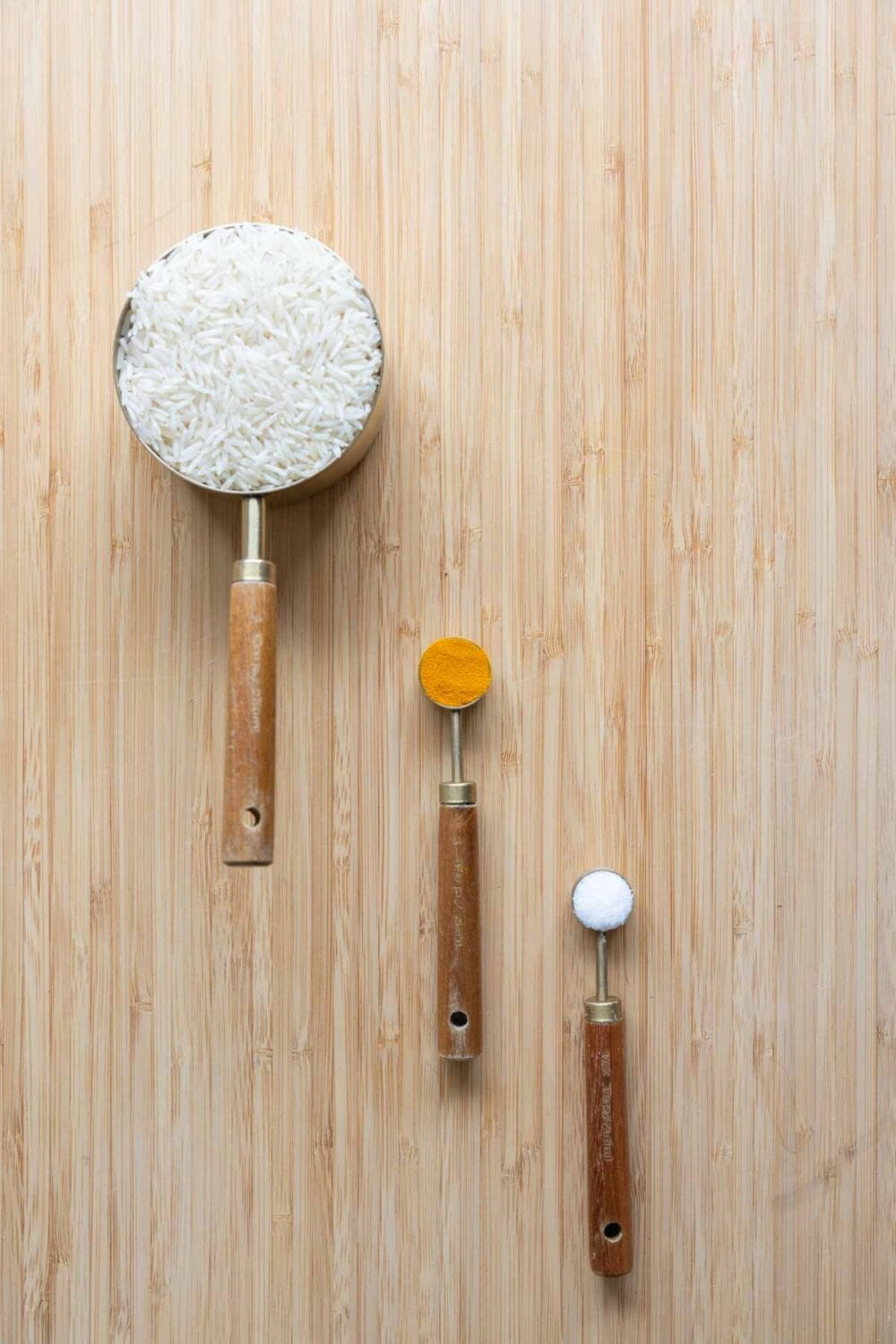 Ingredients for yellow rice laid out on a kitchen counter.