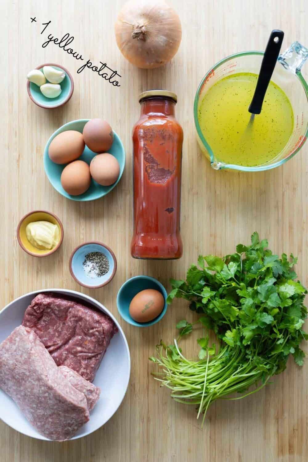 Ingredients for albondigas laid out on a kitchen counter.