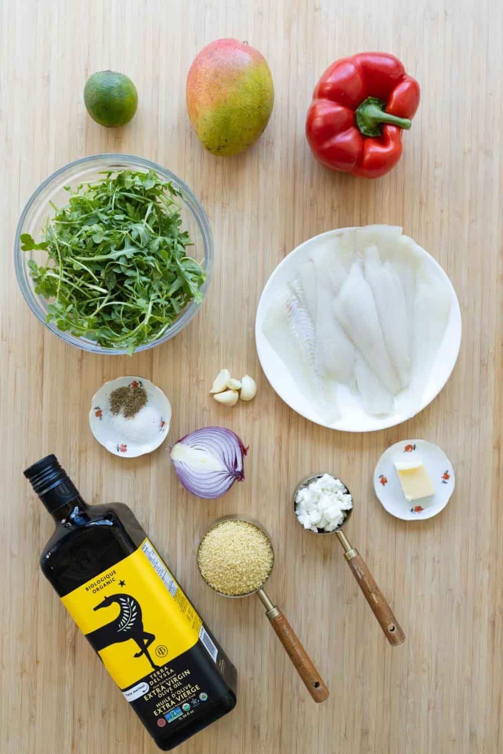 Ingredients for couscous salad and sole filet laid out on a kitchen counter.